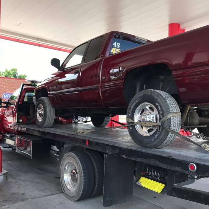 pickup truck secured on a rollback